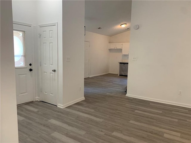 entrance foyer with hardwood / wood-style floors and lofted ceiling