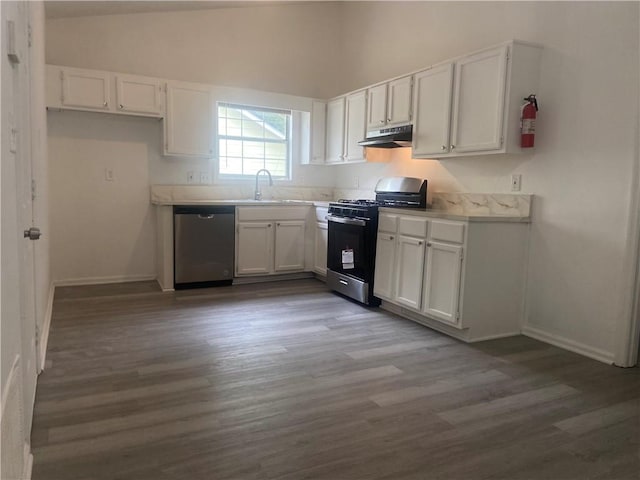 kitchen featuring dark hardwood / wood-style flooring, white cabinets, and appliances with stainless steel finishes