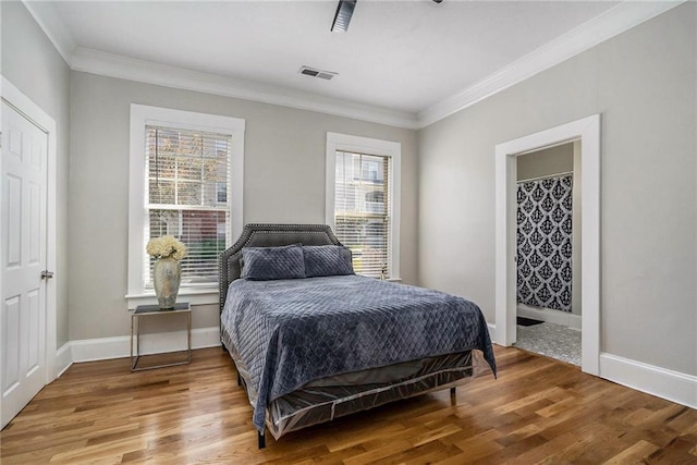 bedroom featuring wood-type flooring and ornamental molding