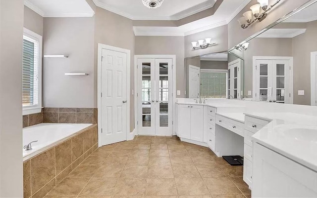 full bath featuring french doors, vanity, crown molding, and a garden tub