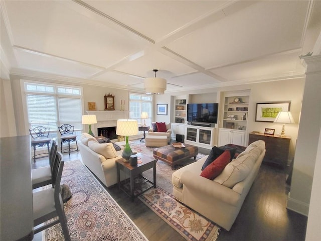 living area with built in features, coffered ceiling, wood finished floors, a fireplace, and ceiling fan