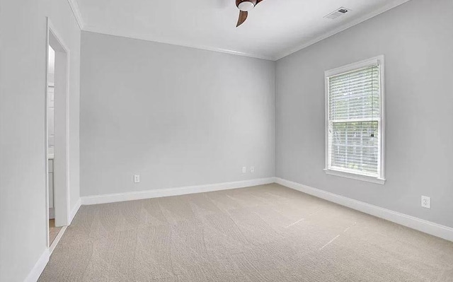 empty room featuring visible vents, carpet floors, baseboards, and ceiling fan