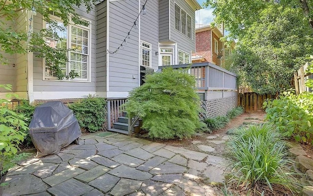 view of patio featuring grilling area and fence