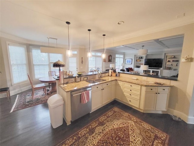 kitchen featuring dishwasher, light stone counters, open floor plan, and a sink