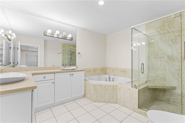 bathroom with vanity, tile patterned floors, and shower with separate bathtub