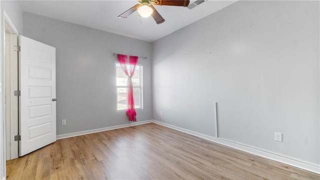 empty room with ceiling fan and light hardwood / wood-style floors