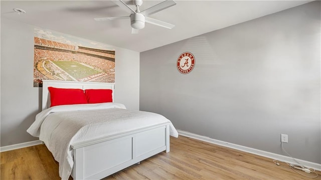 bedroom with ceiling fan and wood-type flooring