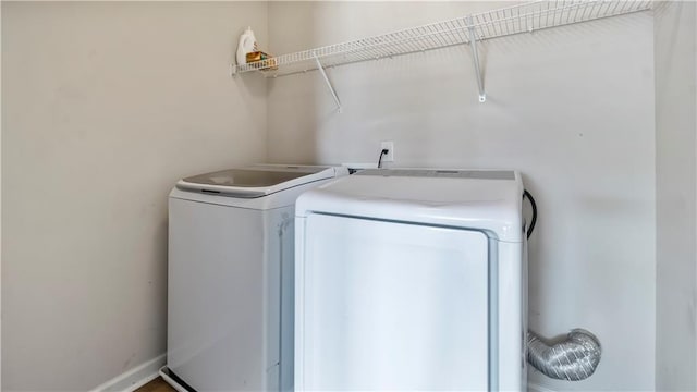 clothes washing area with washing machine and clothes dryer