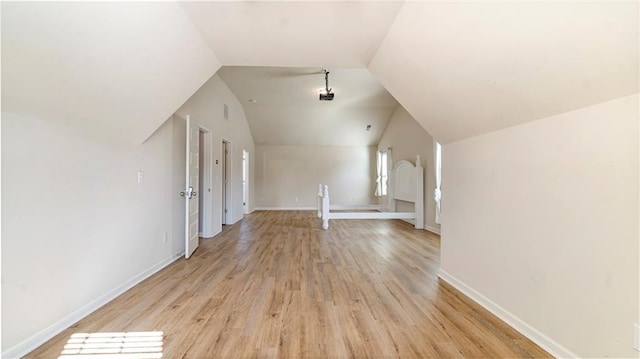 bonus room featuring lofted ceiling and light hardwood / wood-style flooring