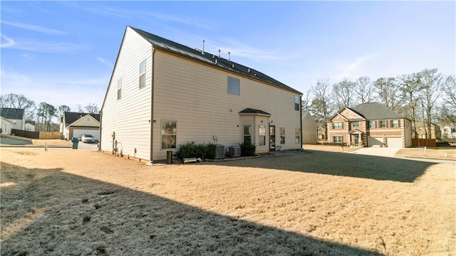 back of house featuring a garage