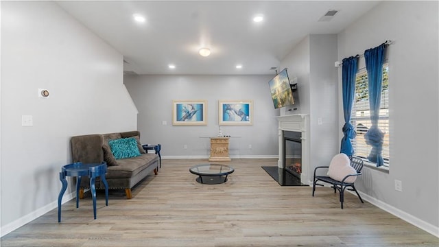 living area with light hardwood / wood-style flooring