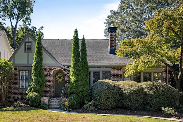 tudor house featuring a front yard