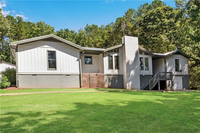 rear view of property with a lawn