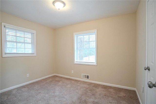 empty room featuring light colored carpet