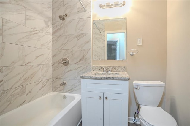 full bathroom featuring tiled shower / bath, vanity, and toilet