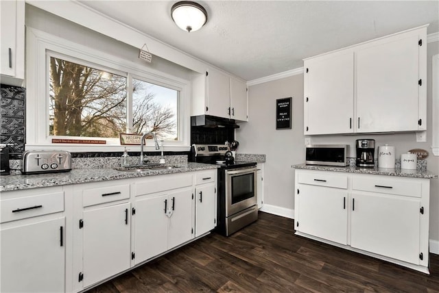 kitchen featuring dark wood-type flooring, ornamental molding, a sink, appliances with stainless steel finishes, and white cabinets