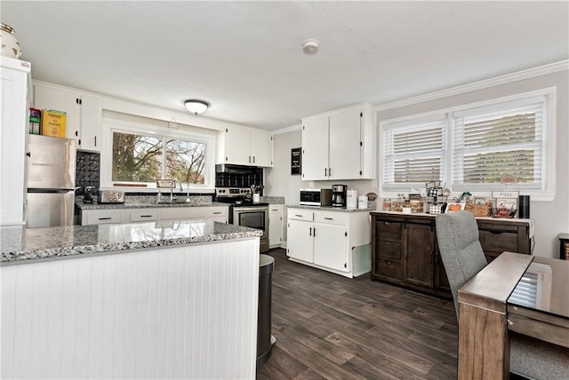 kitchen featuring a sink, light stone counters, dark wood-style floors, stainless steel appliances, and white cabinets