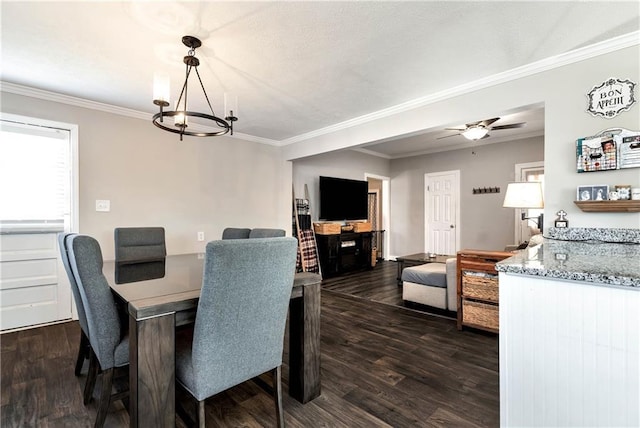 dining room featuring dark wood finished floors, ceiling fan with notable chandelier, and ornamental molding