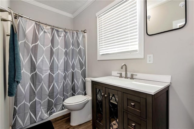 full bathroom featuring toilet, ornamental molding, curtained shower, wood finished floors, and vanity