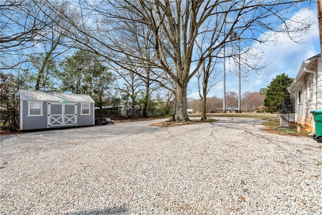 view of yard featuring an outbuilding and a storage unit