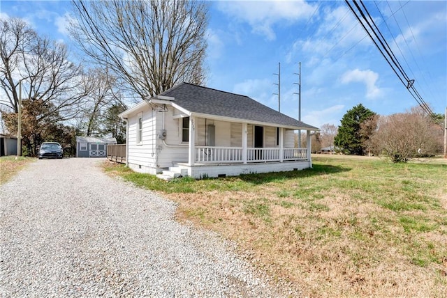 bungalow with roof with shingles, covered porch, an outdoor structure, crawl space, and driveway