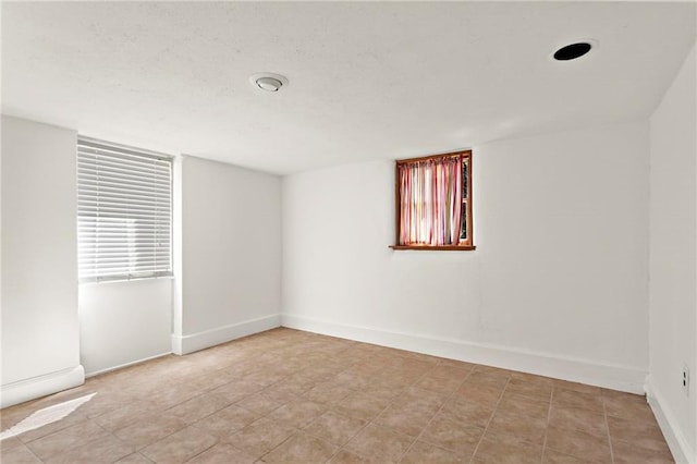 spare room with baseboards