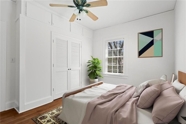 bedroom featuring a closet, a ceiling fan, and dark wood-style flooring