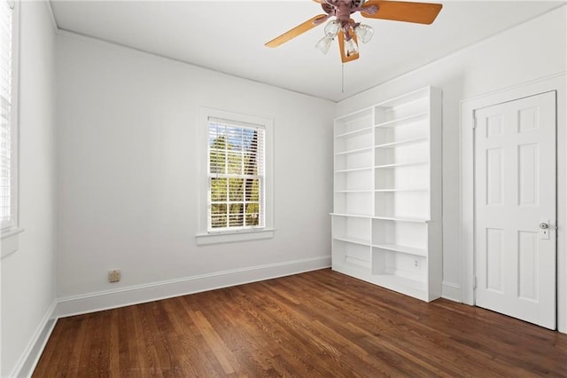 spare room with wood finished floors, baseboards, and ceiling fan