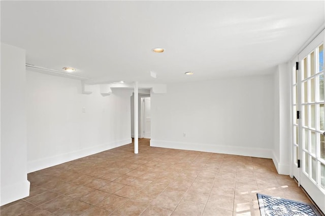 basement featuring light tile patterned floors, baseboards, and recessed lighting