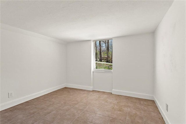 empty room featuring baseboards