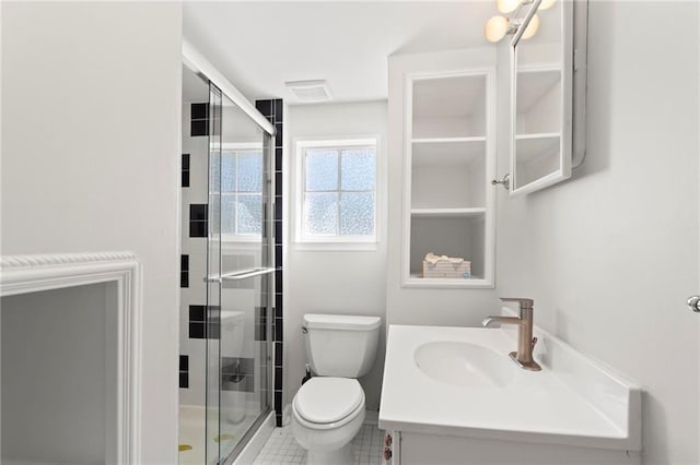 bathroom featuring visible vents, a stall shower, toilet, and vanity