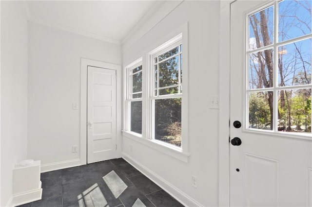 entryway with baseboards and ornamental molding