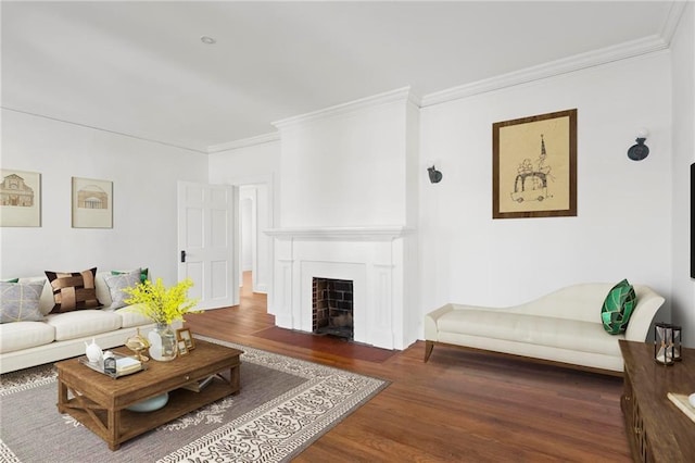 living area featuring a fireplace with flush hearth, crown molding, and wood finished floors