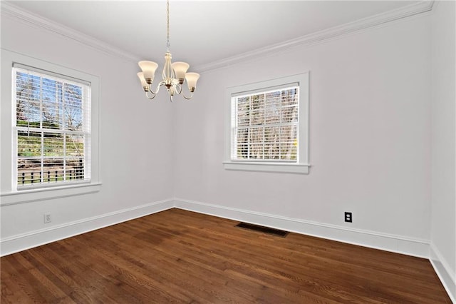 empty room featuring baseboards, visible vents, dark wood-style flooring, and ornamental molding