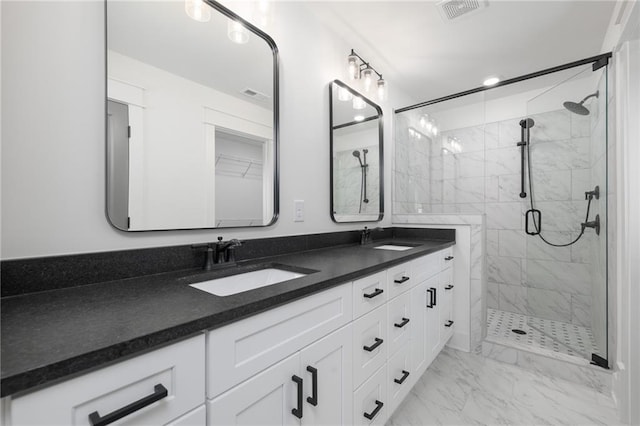 bathroom with a shower with door and vanity