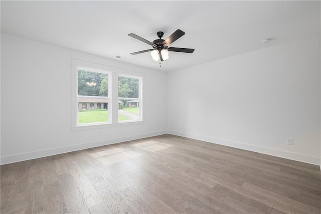 spare room with ceiling fan and hardwood / wood-style floors