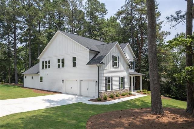 modern farmhouse with a front yard and a garage