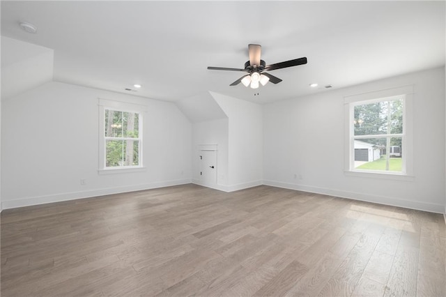 additional living space featuring lofted ceiling, light wood-type flooring, and ceiling fan