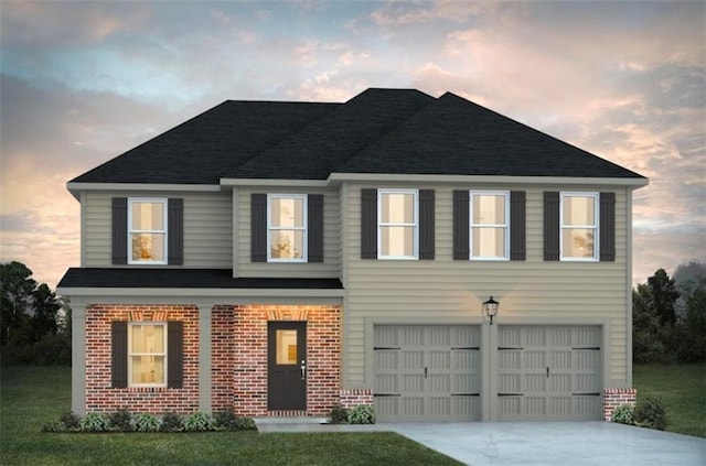 view of front of home featuring a front yard, concrete driveway, brick siding, and an attached garage