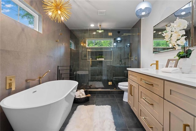 2001 Swazey Dr, Decatur, GA 30032 - full bath featuring toilet, vanity, a soaking tub, a shower stall, and tile walls