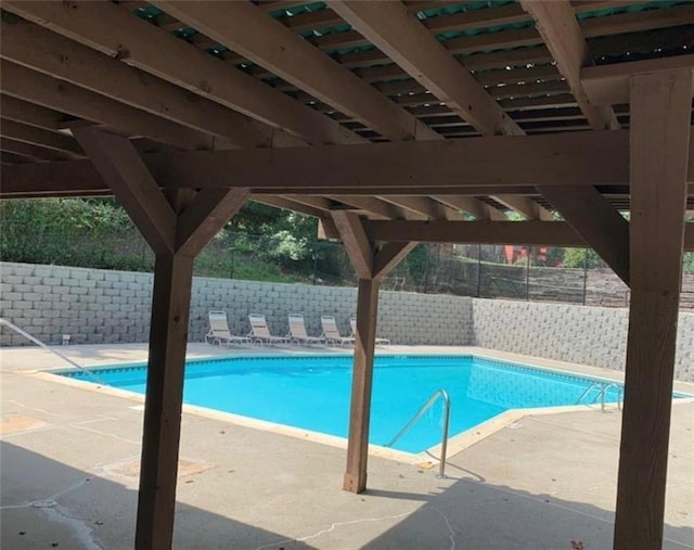 view of swimming pool featuring a patio area