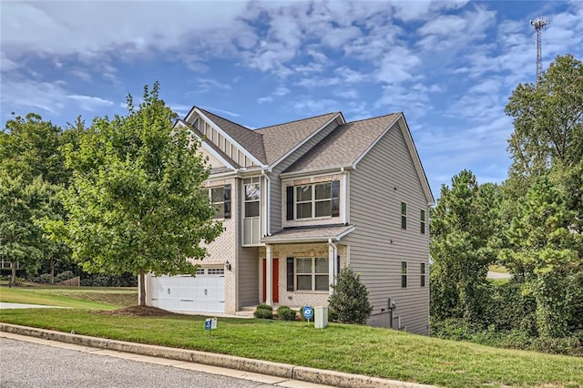 view of front of property with a garage and a front yard