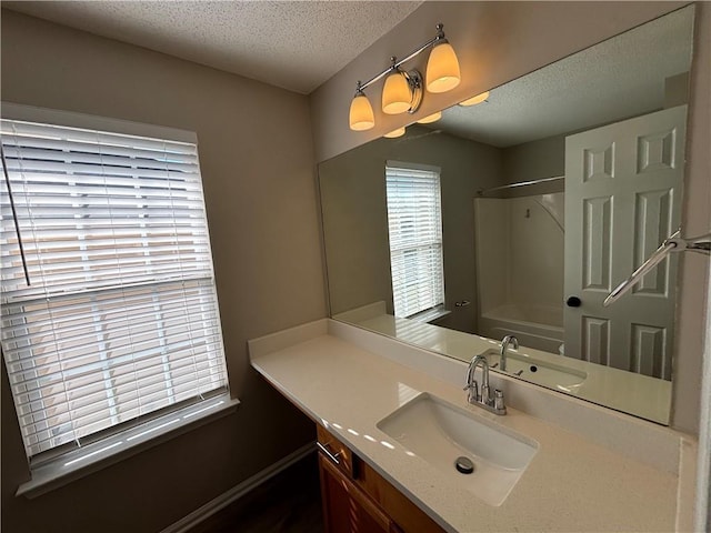 bathroom featuring a textured ceiling and vanity