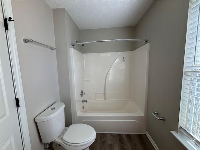 bathroom featuring shower / bath combination, a textured ceiling, hardwood / wood-style flooring, and toilet