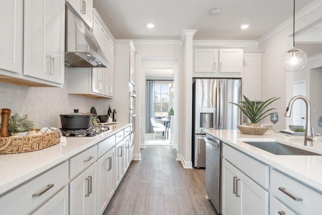 5315 Trescott Path, Cumming, GA 30028 - kitchen with a sink, under cabinet range hood, stainless steel appliances, wood finished floors, and white cabinetry