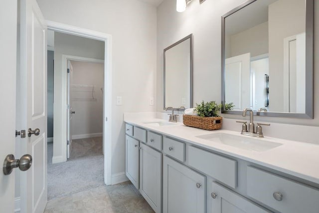 5315 Trescott Path, Cumming, GA 30028 - bathroom featuring double vanity, baseboards, and a walk in closet