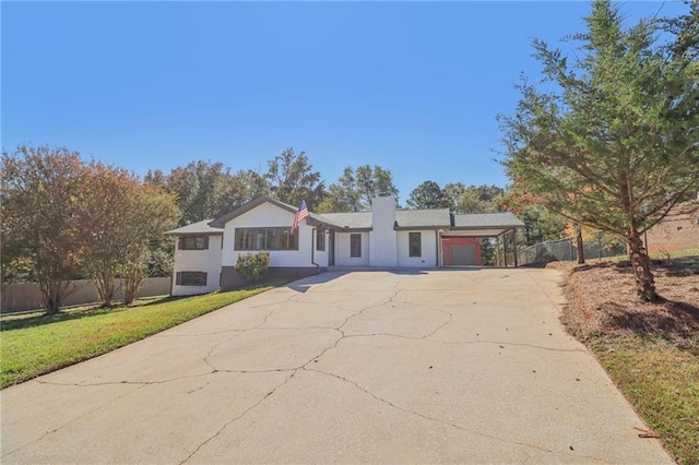 ranch-style house with a garage and a front lawn