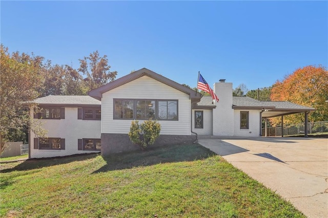 view of front facade with a front yard and a carport