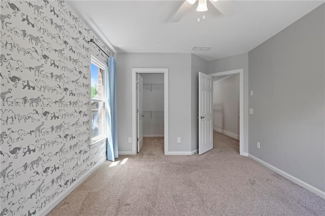 1605 Pavillion Ridge Dr SE, Smyrna, GA 30080 - unfurnished bedroom with carpet floors, a walk in closet, a ceiling fan, and a closet