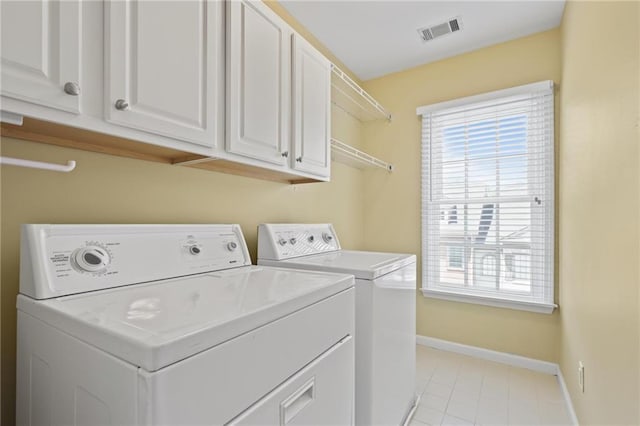 1605 Pavillion Ridge Dr SE, Smyrna, GA 30080 - laundry area with washing machine and dryer, cabinet space, and light tile patterned floors